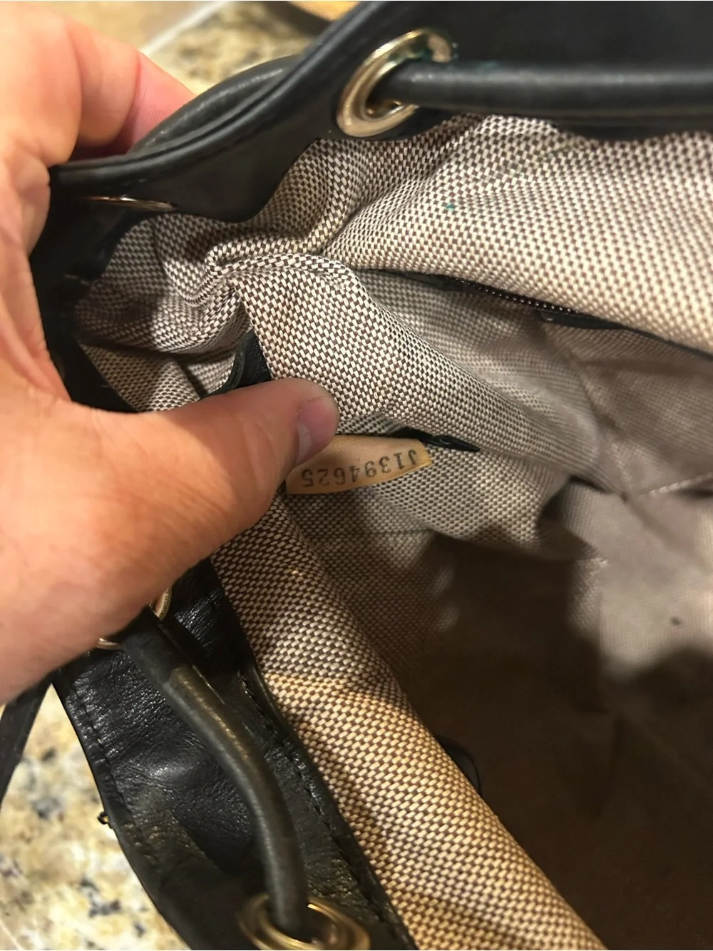 Dooney & Bourke Black Leather Drawstring Backpack with Yellow Stitching